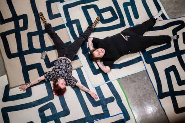  Two college students seen from above make "snow angels" and rest on the art maze blankets during an art exhibition. 